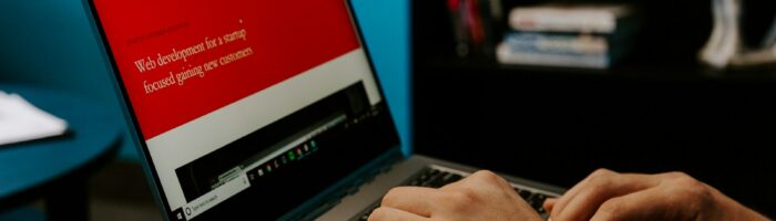 person holding laptop computer inside room
