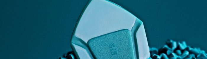a computer mouse sitting on top of a pile of blue chips