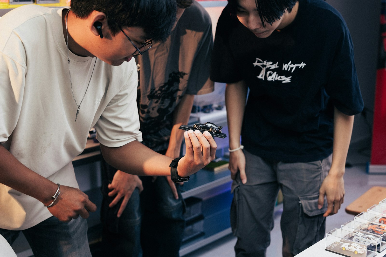 Two people looking at something in a person's hand.